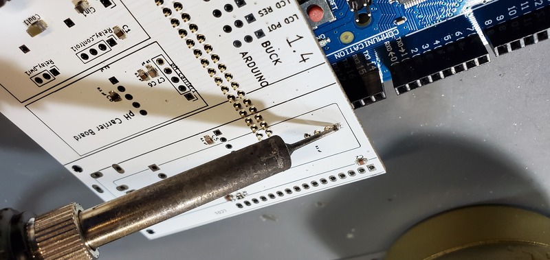 Soldering the first pin into place on Arduino header pins