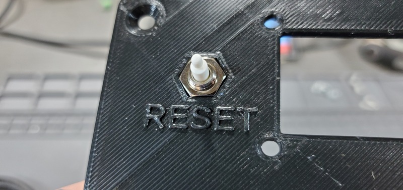 Reset button threaded into the nut on the faceplate
